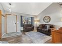 Comfortable living room with hardwood floors and a large window overlooking the neighborhood at 180 S Carlton St, Castle Rock, CO 80104