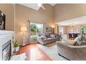 Comfortable living room with a cozy fireplace and views of the backyard at 3780 S Quemoy Way, Aurora, CO 80018