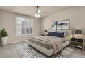 Comfortable bedroom with ceiling fan, large window and neutral color palette at 2210 S Vaughn Way # 103, Aurora, CO 80014