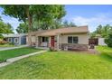 Inviting home exterior with a cozy front porch and lush green lawn at 3064 S Grape Way, Denver, CO 80222