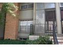 Cozy condo entrance with brick accents, iron railing and secure front door at 3548 S Hillcrest Dr # 2, Denver, CO 80237