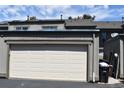 Attached one car garage with solar panels on roof and side entry door at 3548 S Hillcrest Dr # 2, Denver, CO 80237