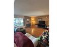 Comfortable living room featuring a brick fireplace and hardwood floors at 3548 S Hillcrest Dr # 2, Denver, CO 80237