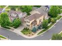 Charming home with a well-maintained yard, lush landscaping, and mature trees visible from this high definition aerial view at 20964 E Greenwood Pl, Aurora, CO 80013