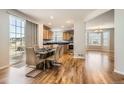 Bright dining room with hardwood floors adjacent to an eat-in kitchen with breakfast nook at 20964 E Greenwood Pl, Aurora, CO 80013