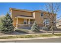 Inviting two-story home with a covered porch and manicured landscaping, creating an appealing curb appeal at 20964 E Greenwood Pl, Aurora, CO 80013
