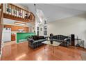 Bright living room featuring hardwood floors, vaulted ceilings and staircase to the loft at 14110 E Dickinson Dr # A, Aurora, CO 80014