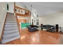 Bright living room featuring hardwood floors, vaulted ceilings and staircase to the loft at 14110 E Dickinson Dr # A, Aurora, CO 80014