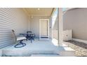 Covered front porch with seating area offering a relaxing spot to enjoy the outdoors at 19000 E 55Th Ave, Denver, CO 80249
