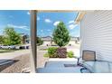 Covered front porch with seating area, and view of the street and neighborhood at 19000 E 55Th Ave, Denver, CO 80249