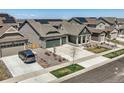 Modern homes with solar panels and landscaped yards in a residential area at 8803 S Winnipeg Ct, Aurora, CO 80016