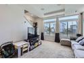 Bright living room featuring neutral carpet, large windows with views, and comfortable seating area at 13589 E 102Nd Pl, Commerce City, CO 80022