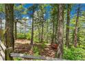 Wooded backyard retreat with mature trees, a split rail fence and scenic views at 14980 Elk Mountain Trl, Littleton, CO 80127