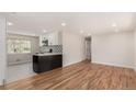 Open-concept living area boasts hardwood floors and abundant natural light, complemented by the adjoining kitchen at 2702 Atchison St, Aurora, CO 80011