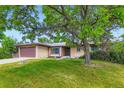Charming one story ranch home featuring a two-car garage and mature landscaping at 2122 S Yank Way, Lakewood, CO 80228
