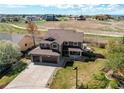 Beautiful exterior with a three-car garage, a covered front porch, and an outdoor seating area at 1678 S Parkdale Cir, Erie, CO 80516