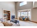 This spacious living room features a cozy fireplace, large windows, and a stylish bookshelf at 1678 S Parkdale Cir, Erie, CO 80516