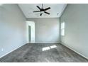 Carpeted bedroom featuring a ceiling fan, ample natural light, and neutral walls at 152 Pelican Ave, Brighton, CO 80601