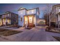 Exterior view of home with a long driveway and two-car garage at 2550 Xanthia Ct, Denver, CO 80238