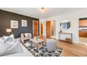 Stylish living room showcasing hardwood floors, modern decor, and a seamless flow into other living spaces at 2001 Grove St, Denver, CO 80211