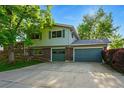 Two-story home with a well-kept lawn, mature trees, and a spacious three-car garage at 1905 S Linden Ct, Denver, CO 80224