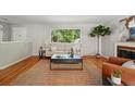 Comfortable living room with a jute rug, a large window and bright light at 1905 S Linden Ct, Denver, CO 80224
