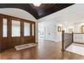 Bright foyer with hardwood floors, staircase with iron railing, and a view into the living spaces at 5340 S Logan Dr, Greenwood Village, CO 80121