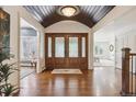 Grand foyer featuring hardwood floors, high ceilings, and stunning double doors with leaded glass at 5340 S Logan Dr, Greenwood Village, CO 80121