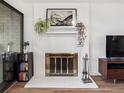 Bright white brick fireplace with gold trim, decorated with art and plants at 800 N Pearl St # 709, Denver, CO 80203