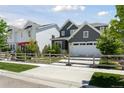 Charming neighborhood street featuring a gray two-story home with a well-kept lawn at 13334 Blue Amber Ct, Parker, CO 80134