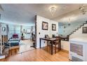 Open-concept living room with hardwood floors and combined dining area offering seamless living at 14486 E Hawaii Cir # D, Aurora, CO 80012