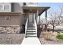 Charming front entrance with stone accents and a covered porch at 18143 E 104Th Way, Commerce City, CO 80022