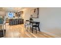 Modern dining room with sleek black table, four chairs, and stylish hardwood floors near the kitchen at 1810 Irving St # 4, Denver, CO 80204