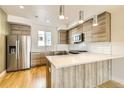 Well-equipped kitchen boasts stainless steel appliances, quartz countertops, and modern wood cabinetry at 1810 Irving St # 4, Denver, CO 80204
