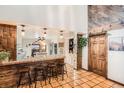 Eat-in kitchen with a breakfast bar, rustic wood accents, and terra cotta floors at 454 S Eaton St, Lakewood, CO 80226