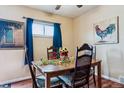Cozy dining room features a wooden table, seating for four, bright sunflowers, and colorful wall art at 714 S Tabor St, Elizabeth, CO 80107