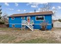 Charming blue two-story home with brown roof, white trim and welcoming front porch with white stairs at 714 S Tabor St, Elizabeth, CO 80107