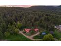 Expansive aerial view of the property showcasing the homes and surrounding forest landscape at 245 N County Highway 67, Sedalia, CO 80135