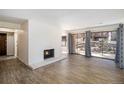 Open living area with a brick fireplace, wood floors, and sliding glass doors to the outside at 500 Manhattan Dr # B1, Boulder, CO 80303