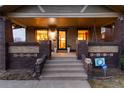 Welcoming front porch featuring brick columns, cozy ambiance, and inviting entrance to the home at 3044 W 37Th Ave, Denver, CO 80211