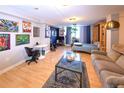 Inviting living area with stylish decor, featuring hardwood floors, comfortable seating, and vibrant wall art at 1196 N Grant St # 104, Denver, CO 80203