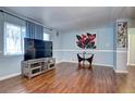 Bright living room with hardwood floors, large windows, and stylish decor at 4070 W Exposition Ave, Denver, CO 80219