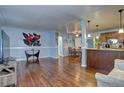 Spacious living room with beautiful hardwood floors that flows into the kitchen and dining area at 4070 W Exposition Ave, Denver, CO 80219