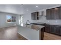 Bright kitchen features granite counters, stainless steel appliances and an island with sink at 13531 E 99Th Pl, Commerce City, CO 80022