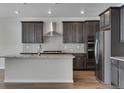 Modern kitchen features stainless steel appliances, granite countertops, and a large island at 13531 E 99Th Pl, Commerce City, CO 80022