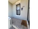 A welcoming entrance of a home with concrete porch and protective bars on the window at 914 E Iowa Ave, Denver, CO 80210