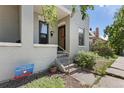 Charming exterior view of home featuring a classic brick facade, steps to the front door, and beautiful landscaping at 914 E Iowa Ave, Denver, CO 80210