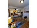 An open-concept living room flows into a kitchen with hardwood floors at 914 E Iowa Ave, Denver, CO 80210