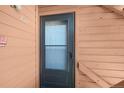 Close-up of the unit's front door with modern screen and painted trim that complements the overall exterior at 4681 S Decatur St # 227, Englewood, CO 80110