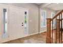 The front foyer includes tile flooring and a beautiful white front door with sidelights at 9954 Heywood St, Highlands Ranch, CO 80130